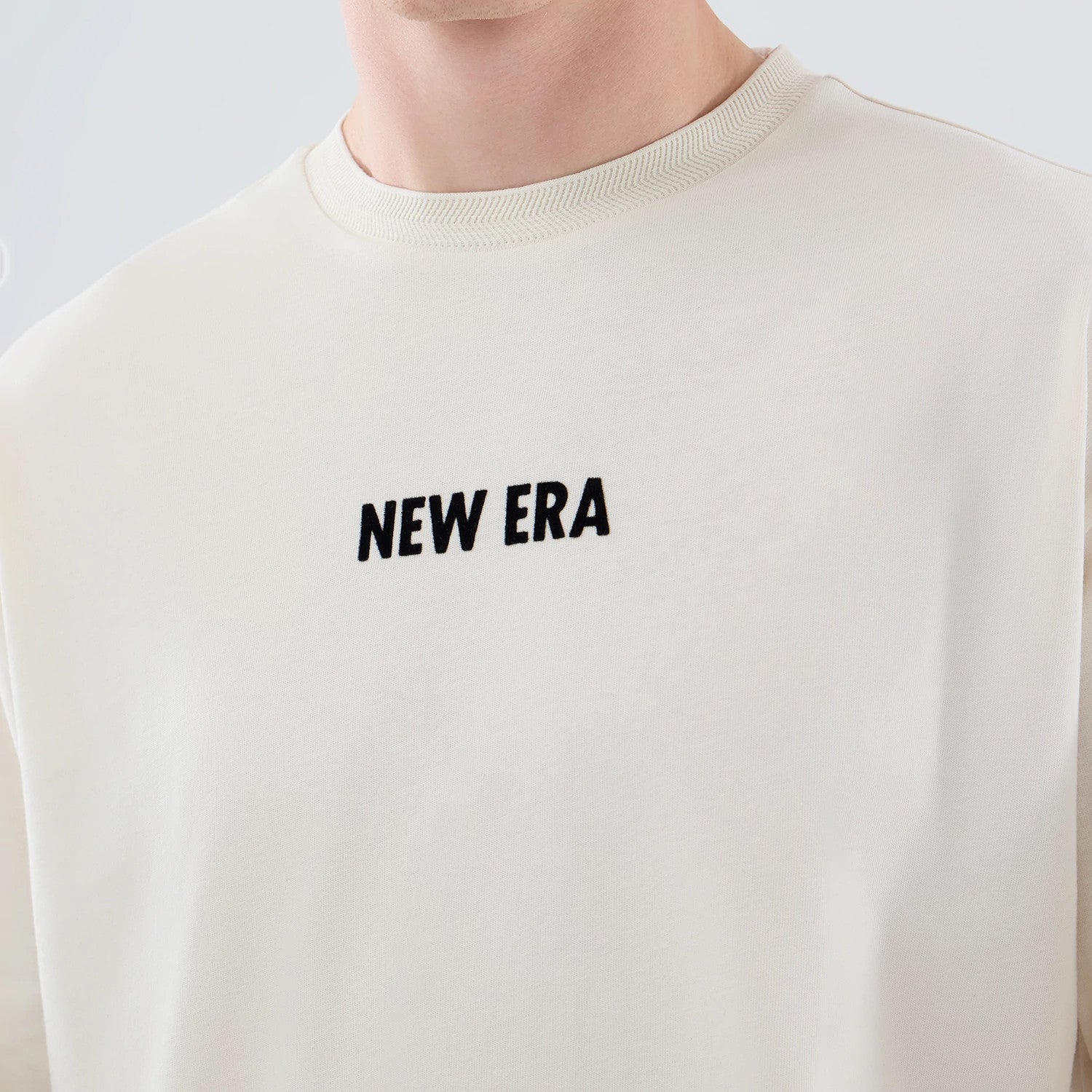 The model is wearing this New Era Cap Graphic Oversized T-Shirt in cream. 5