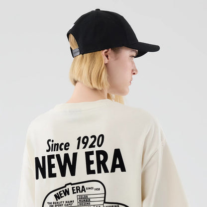 The model is wearing this New Era Cap Graphic Oversized T-Shirt in cream. 8