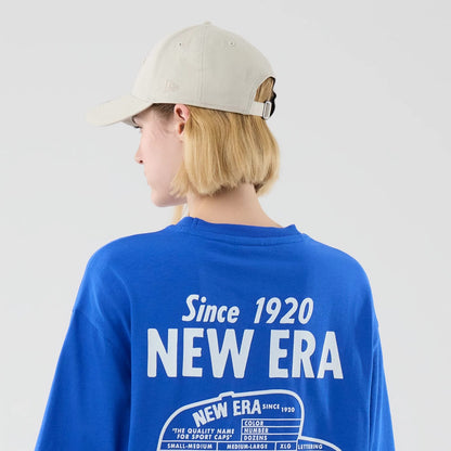 The model is wearing this New Era Cap Graphic Oversized T-Shirt in bright blue. 8