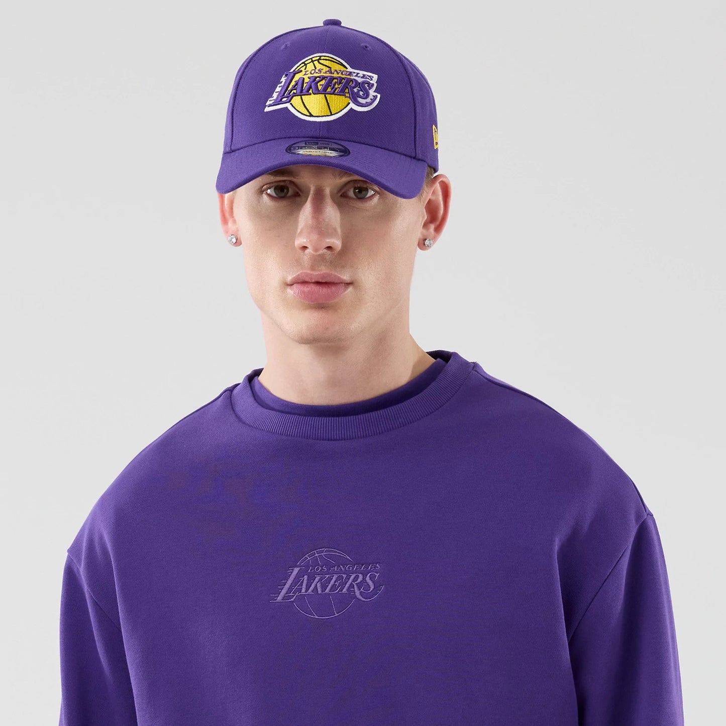 The model is wearing this NBA League Essential LA Lakers Oversized Crew Neck Sweater in purple. 6