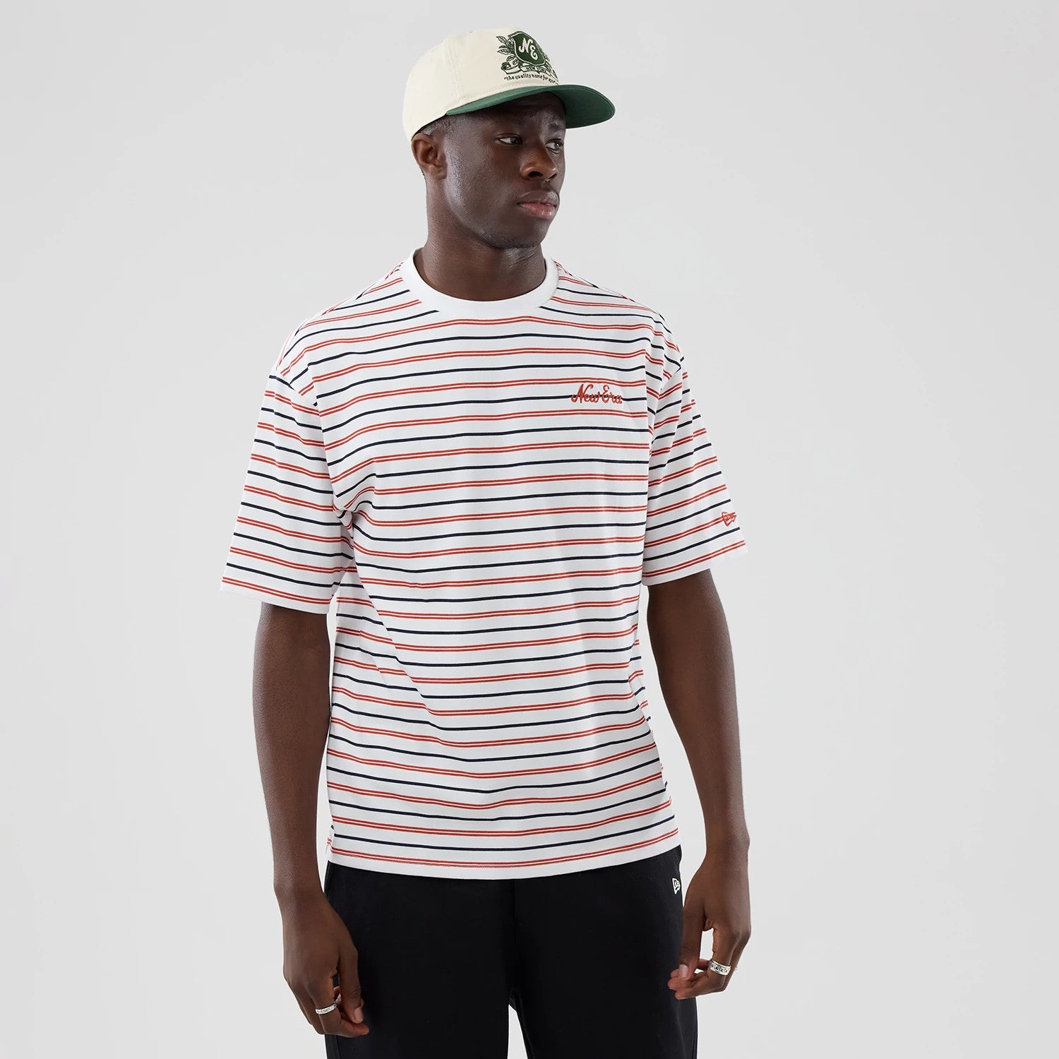 The model is wearing this New Era Stripe Oversized T-Shirt in white. 3