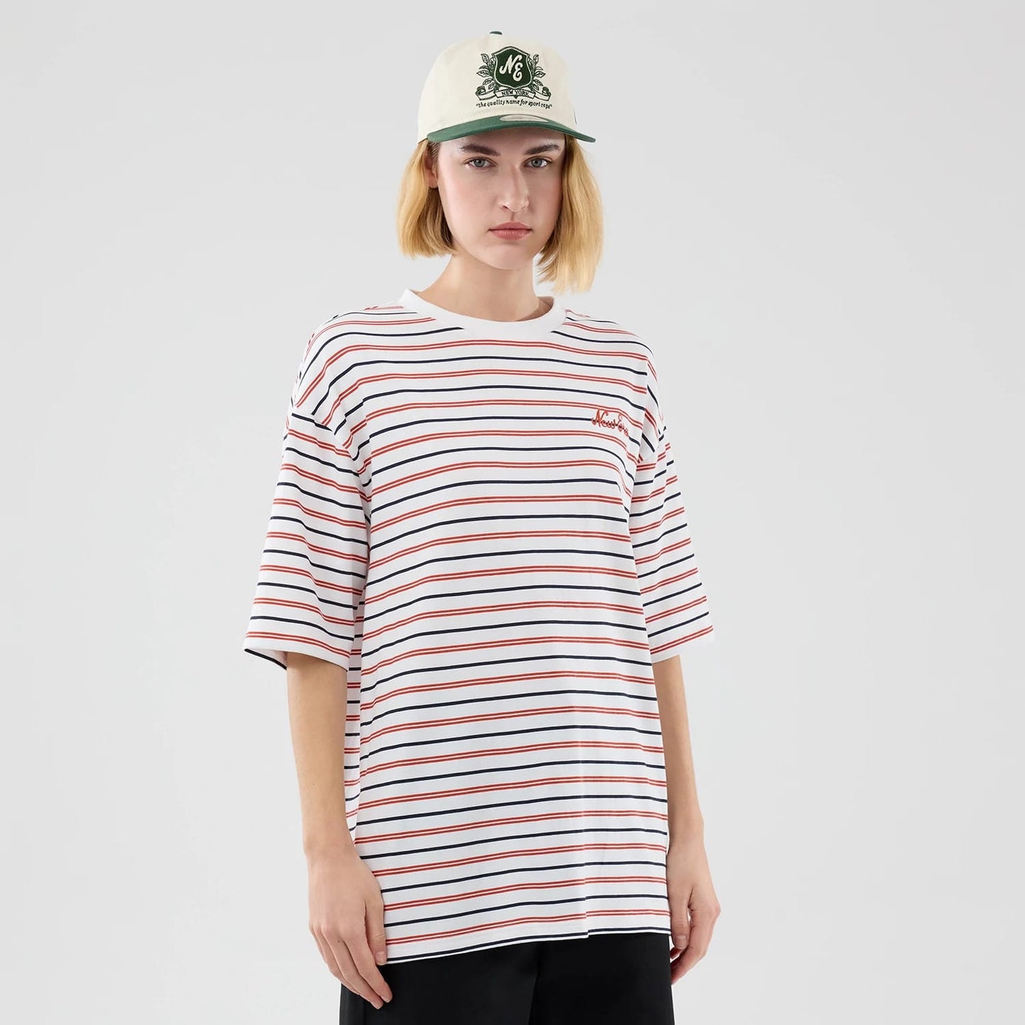 The model is wearing this New Era Stripe Oversized T-Shirt in white. 4