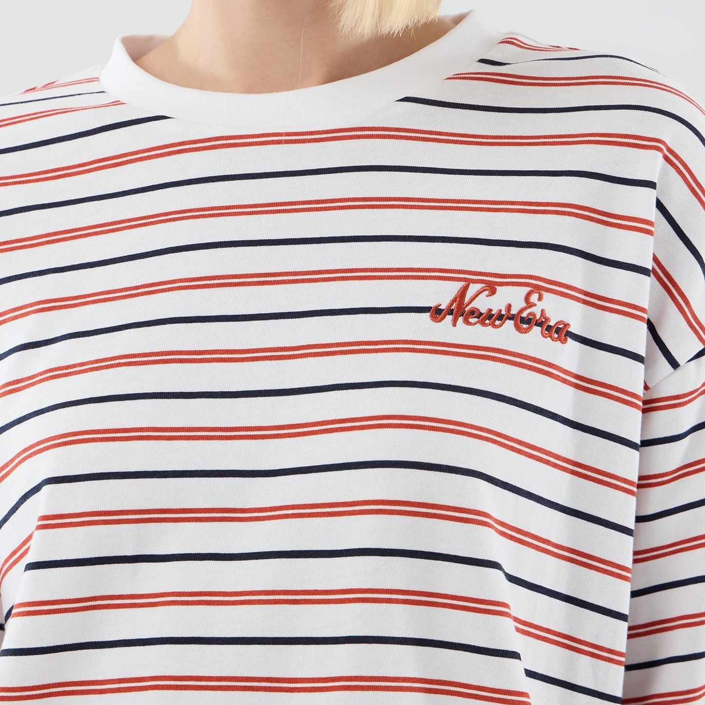 The model is wearing this New Era Stripe Oversized T-Shirt in white. 6