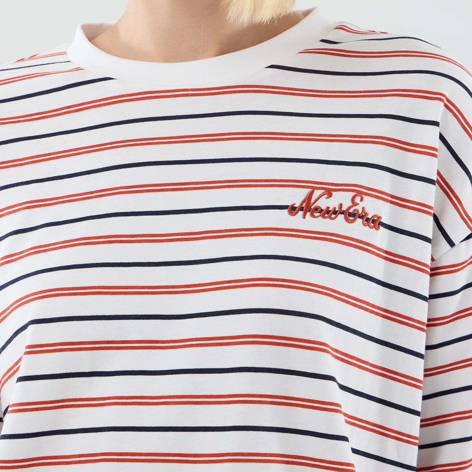 The model is wearing this New Era Stripe Oversized T-Shirt in white. 6