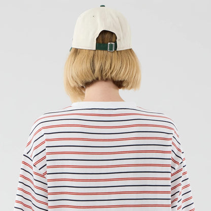 The model is wearing this New Era Stripe Oversized T-Shirt in white. 8