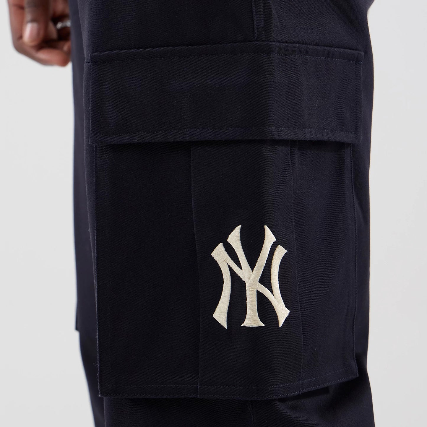 The model is wearing these MLB New York Yankees Cargo Trousers in navy. 7