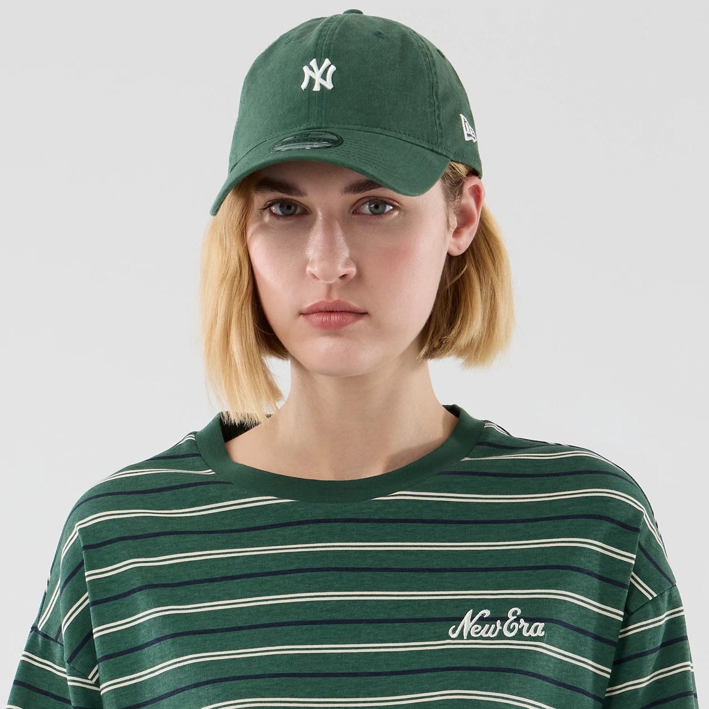 The model is wearing this New Era Stripe Oversized T-Shirt in dark green. 6