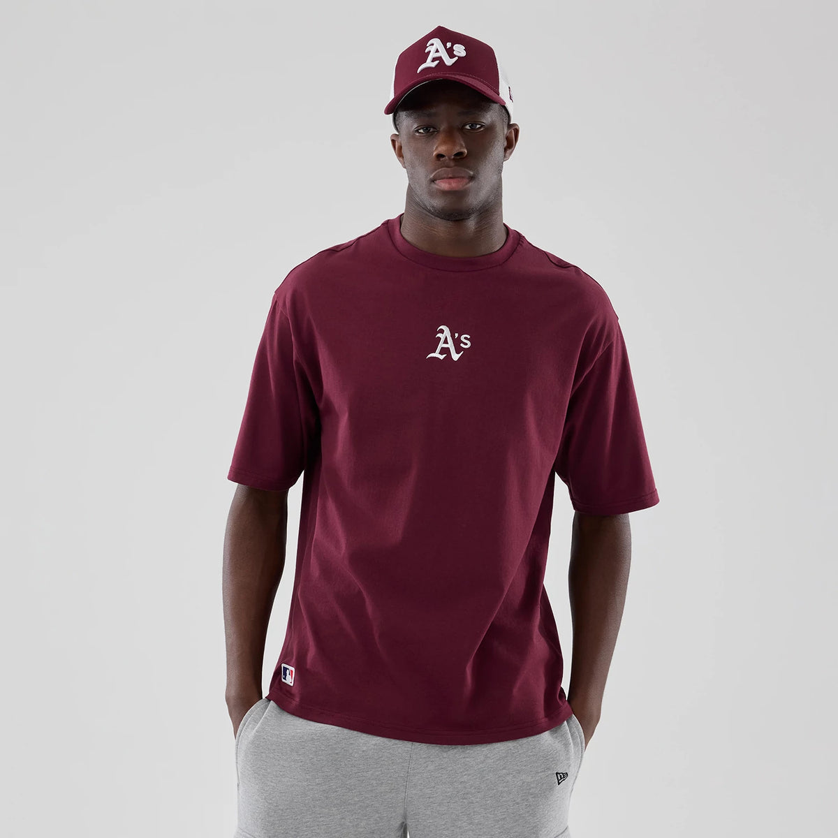 The model is wearing this MLB Midi League Essential Athletics Oversized T-Shirt in dark red. 3