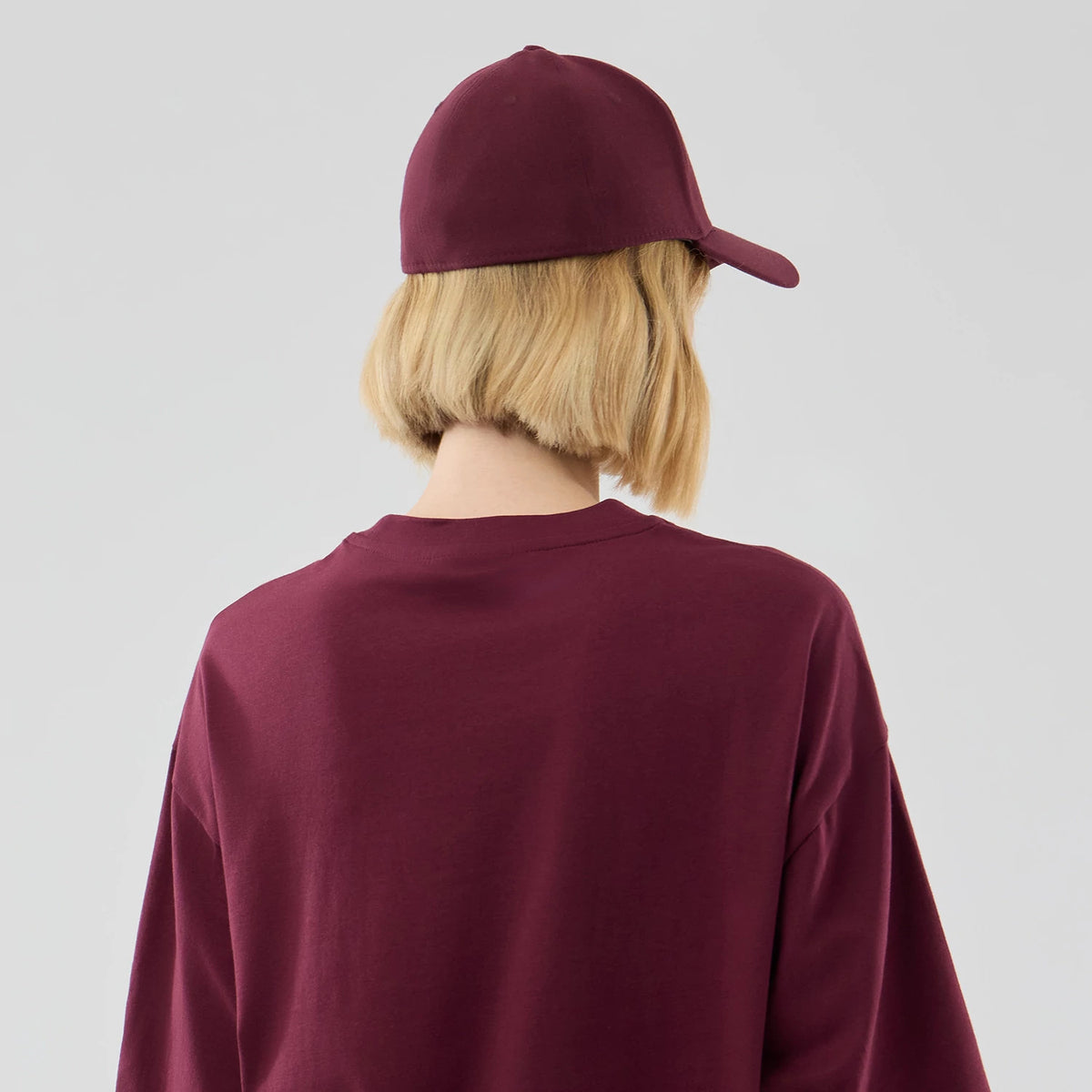 The model is wearing this MLB Midi League Essential Athletics Oversized T-Shirt in dark red. 8