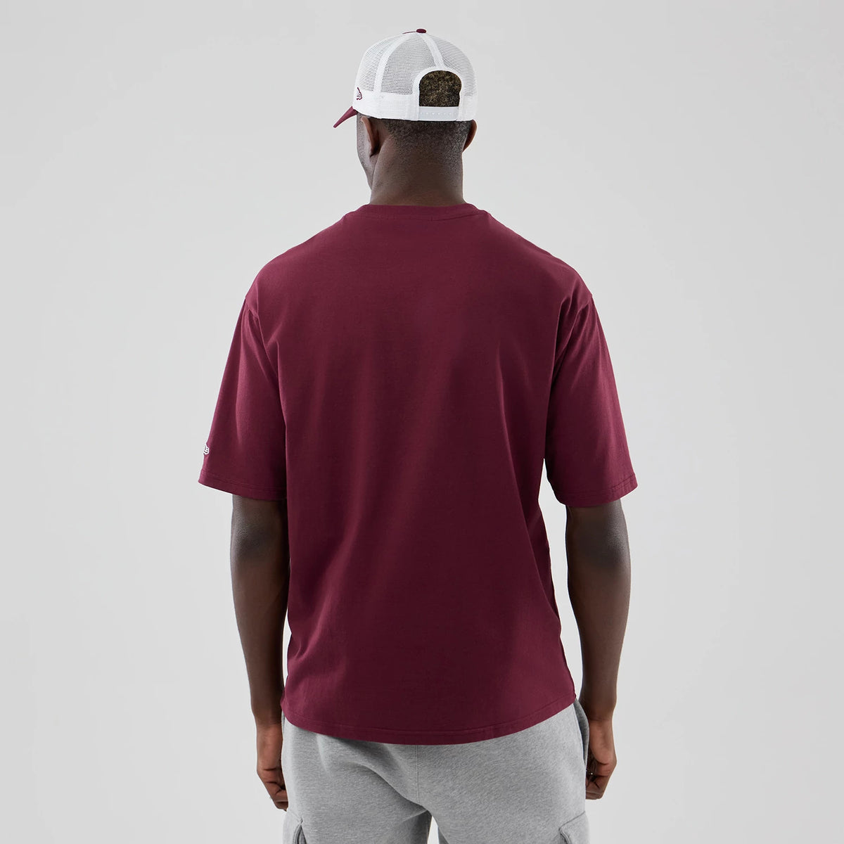The model is wearing this MLB Midi League Essential Athletics Oversized T-Shirt in dark red. 2