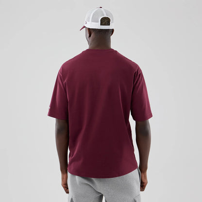 The model is wearing this MLB Midi League Essential Athletics Oversized T-Shirt in dark red. 2