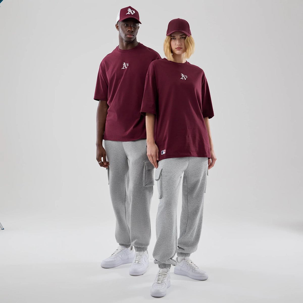 The model is wearing this MLB Midi League Essential Athletics Oversized T-Shirt in dark red. 1