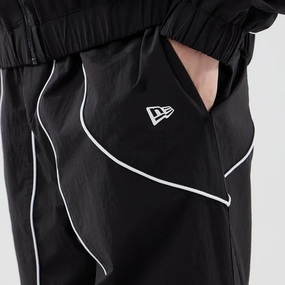 The model is wearing these MLB Piping Track LA Dodgers Track Pants in black. 6