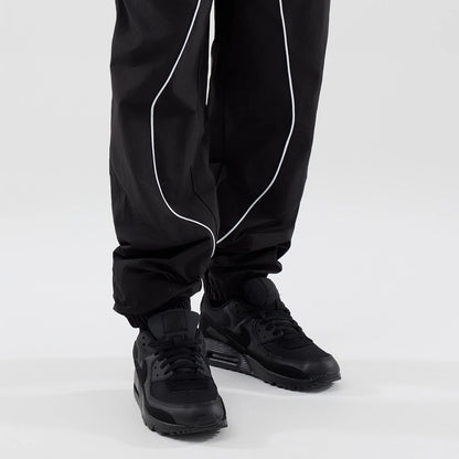 The model is wearing these MLB Piping Track LA Dodgers Track Pants in black. 7