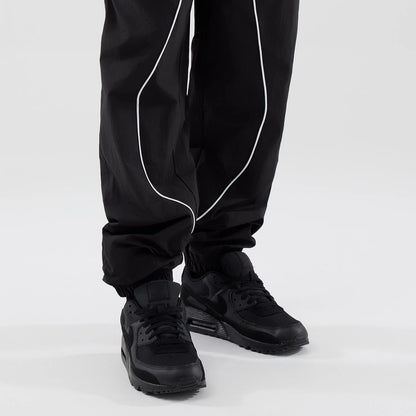 The model is wearing these MLB Piping Track LA Dodgers Track Pants in black. 7
