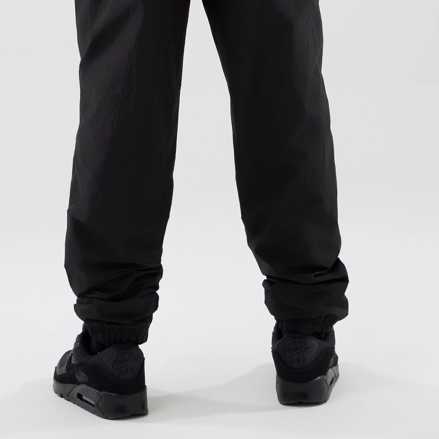 The model is wearing these MLB Piping Track LA Dodgers Track Pants in black. 4