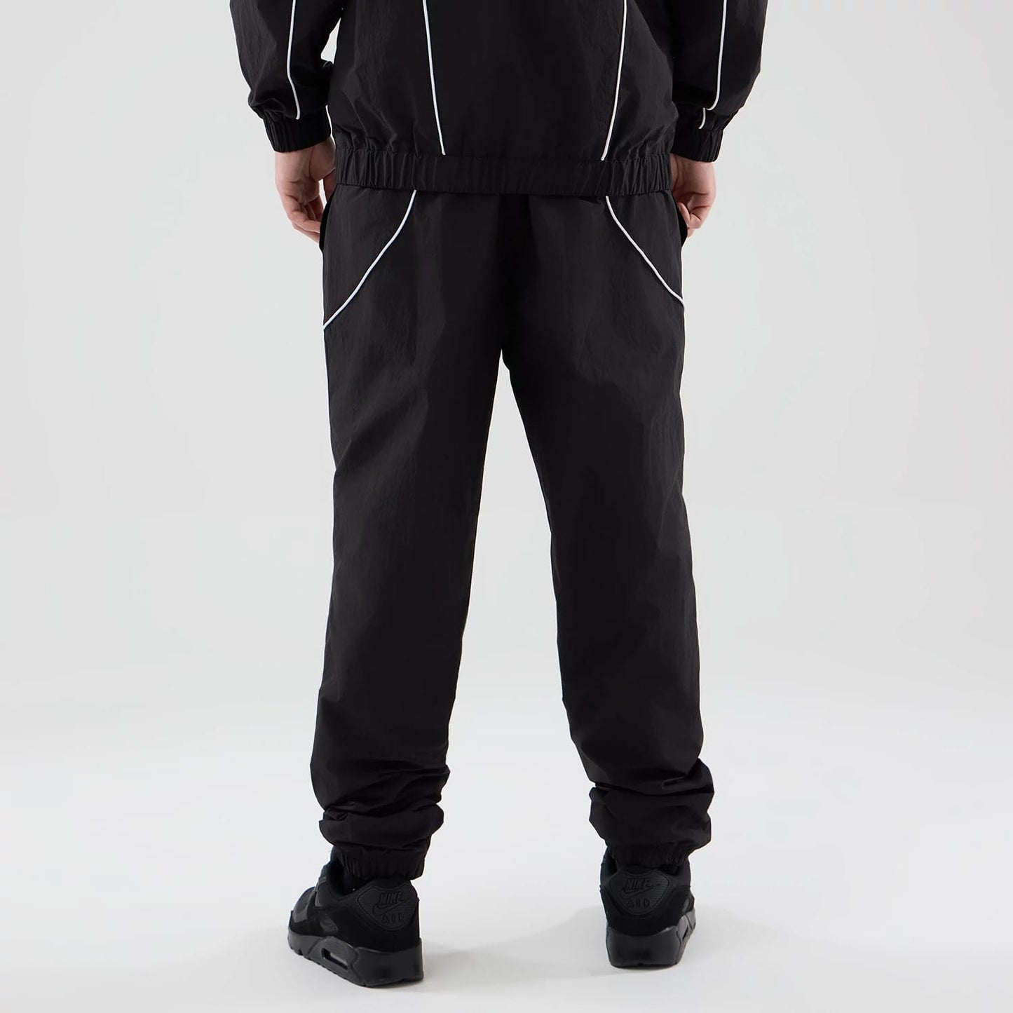The model is wearing these MLB Piping Track LA Dodgers Track Pants in black. 2