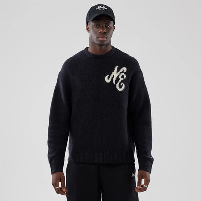 The model is wearing this New Era Knit Knitted Sweater in navy. 3
