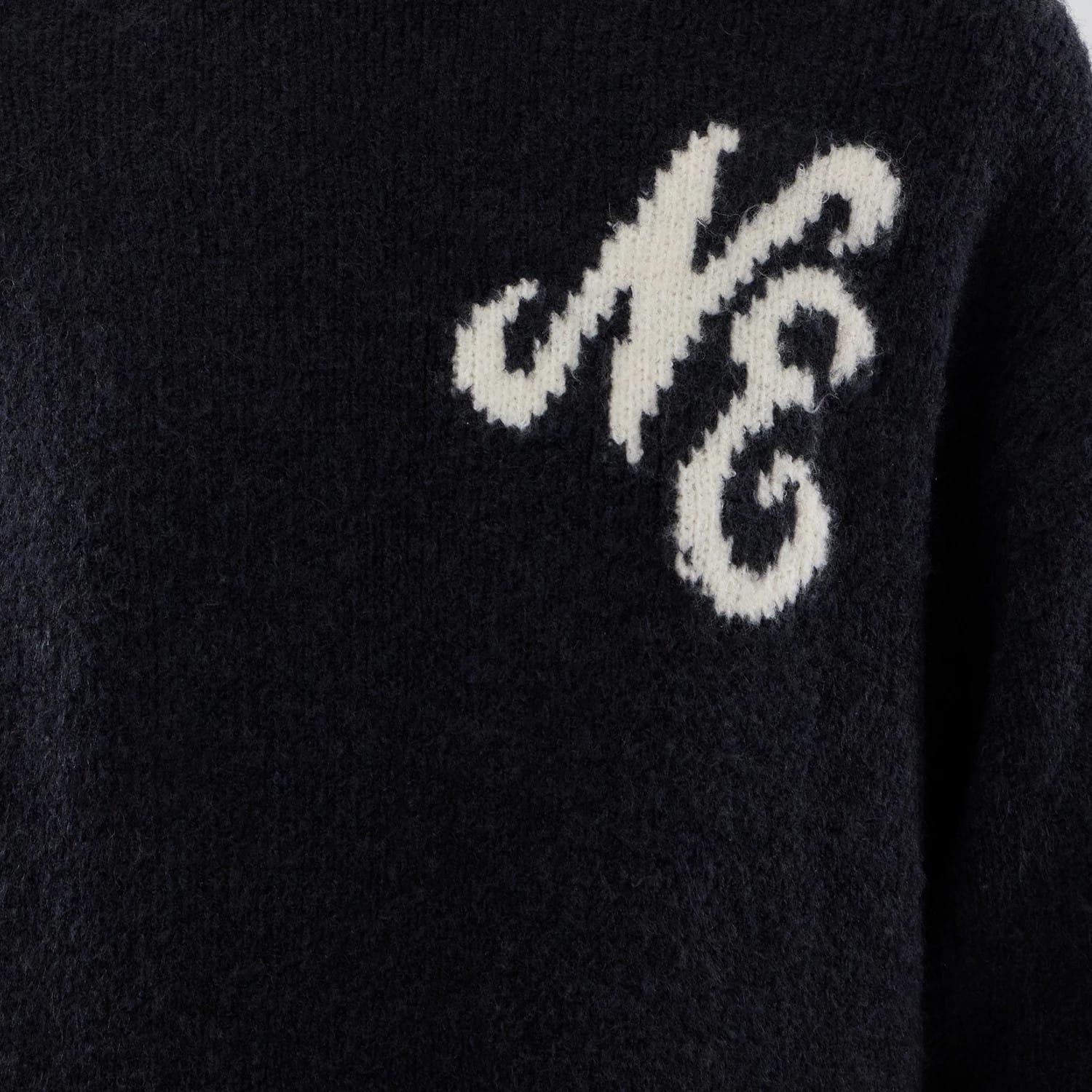 The model is wearing this New Era Knit Knitted Sweater in navy. 6