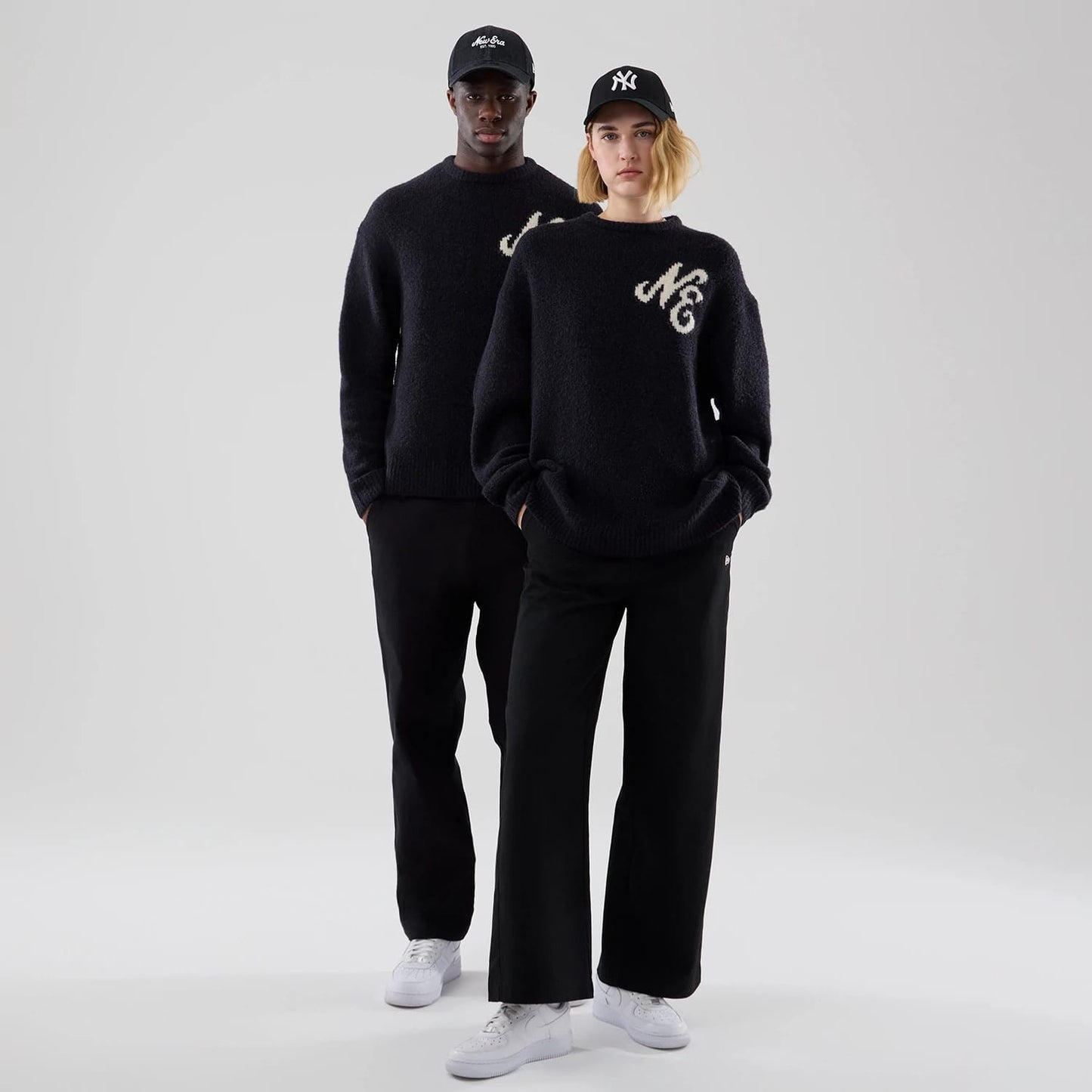 The model is wearing this New Era Knit Knitted Sweater in navy. 1