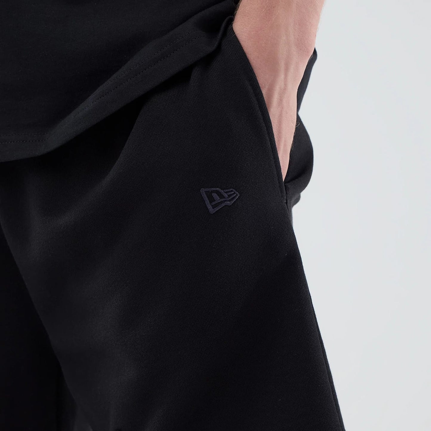 The model is wearing these NBA League Essential Chicago Bulls Oversized Shorts in black. 5