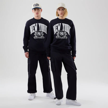 The model is wearing this MLB Arch Graphic New York Yankees Oversized Crew Neck Sweater in navy. 1