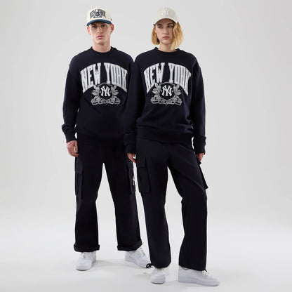 The model is wearing this MLB Arch Graphic New York Yankees Oversized Crew Neck Sweater in navy. 1