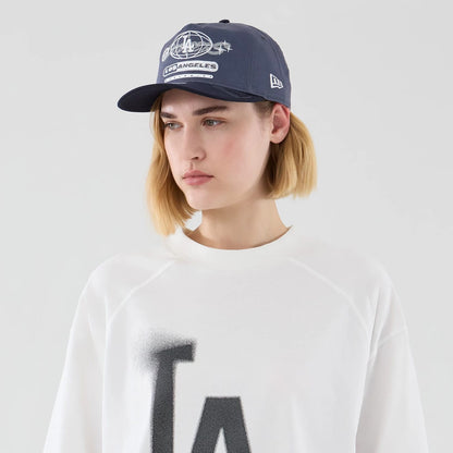 The model is wearing this MLB Graphic LA Dodgers Boxy T-Shirt in white. 5