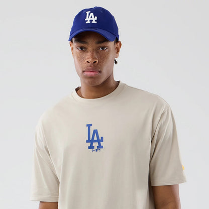 The model is wearing this MLB Food Graphic LA Dodgers Oversized T-Shirt in cream. 3