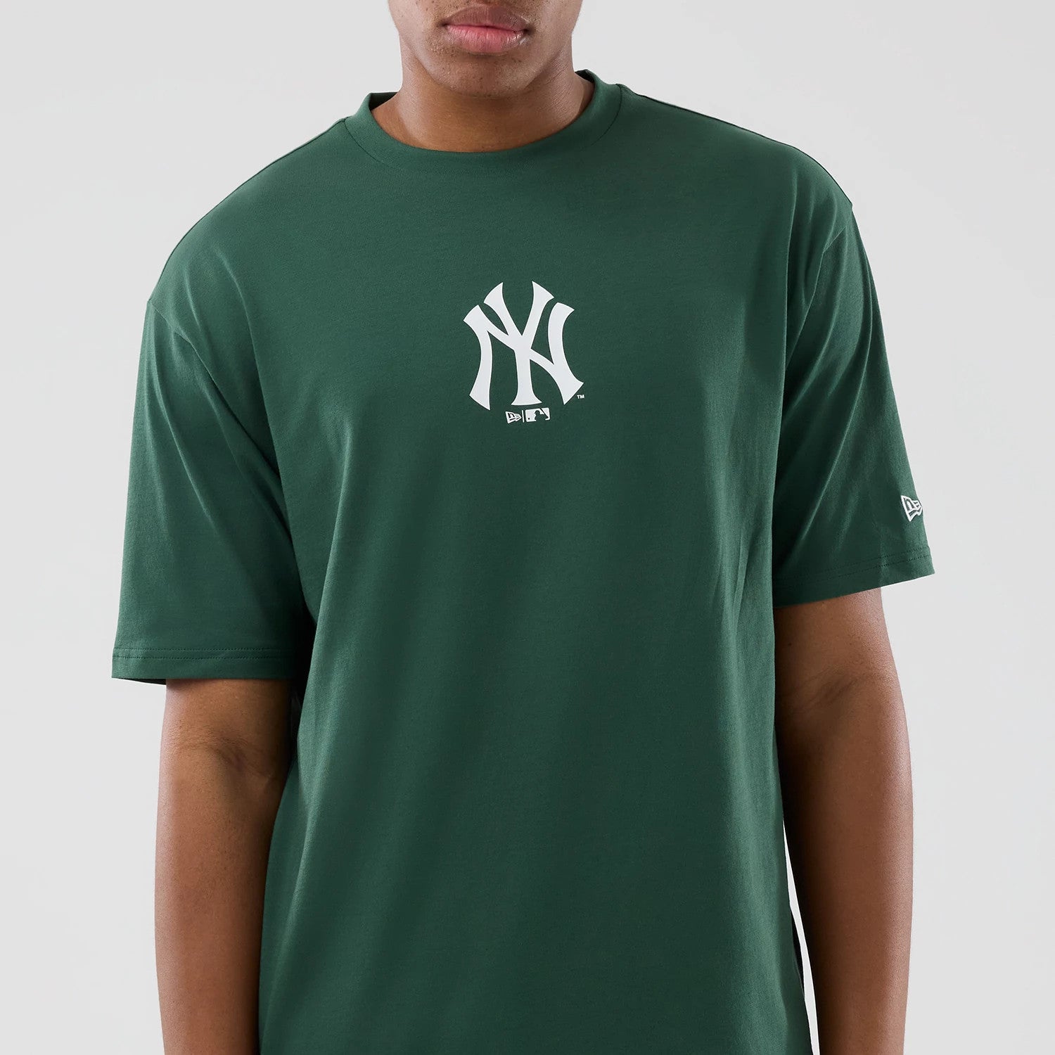 The model is wearing this MLB Food Graphic New York Yankees Oversized T-Shirt in dark green. 3