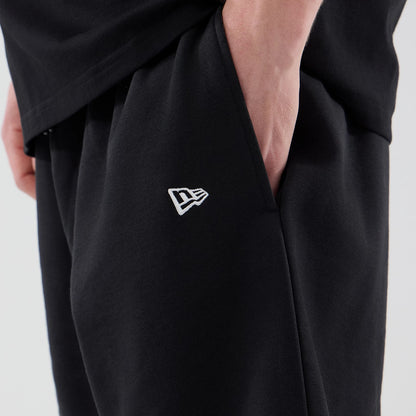 The model is wearing these MLB Logo Graphic New York Yankees Oversized Shorts in black. 5