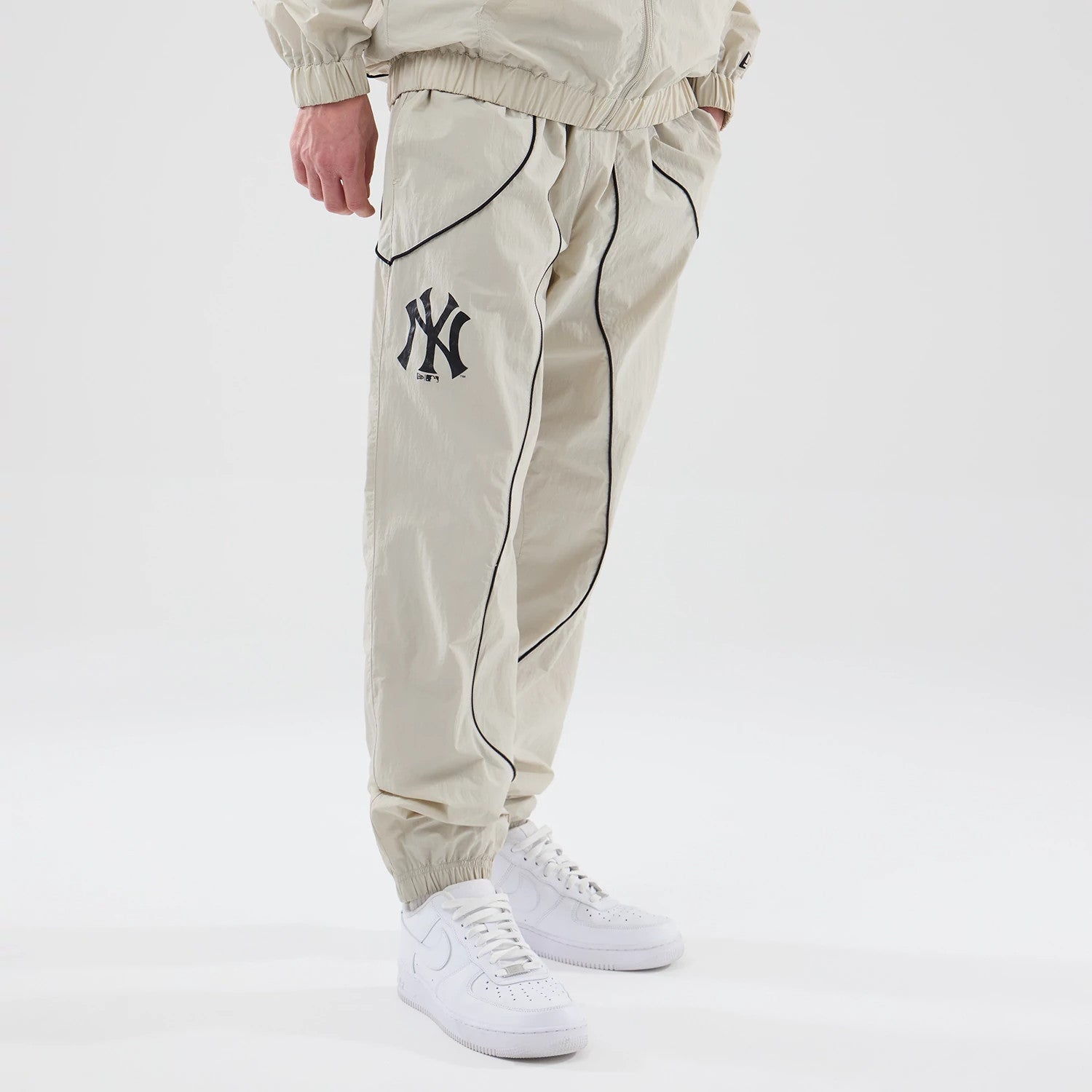 The model is wearing these MLB Piping Track New York Yankees Track Pants in cream. 3