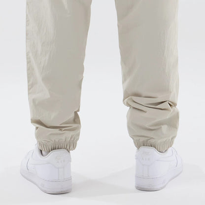 The model is wearing these MLB Piping Track New York Yankees Track Pants in cream. 7