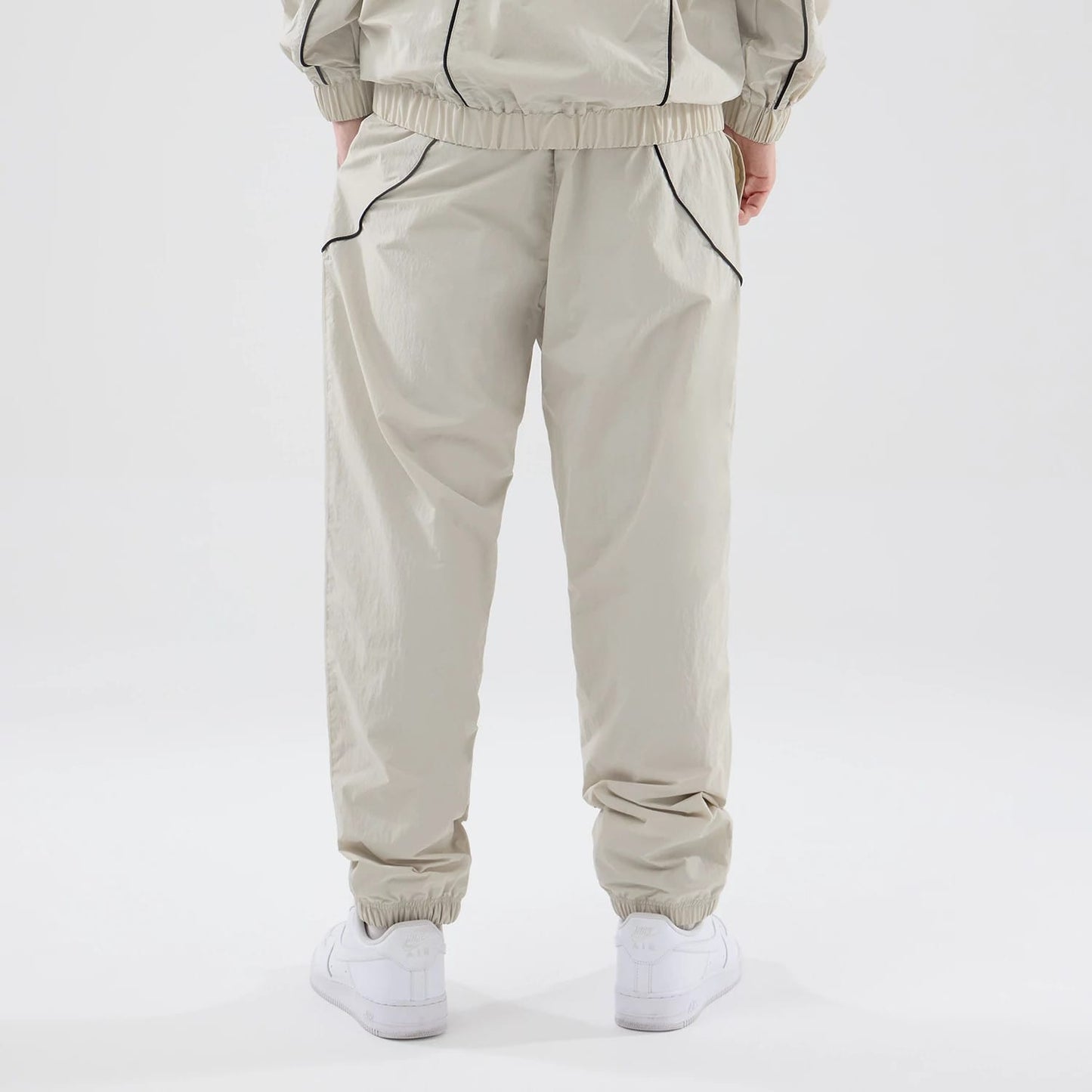 The model is wearing these MLB Piping Track New York Yankees Track Pants in cream. 2