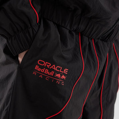 The model is wearing these Red Bull Racing Piping Track Pants in black. 5