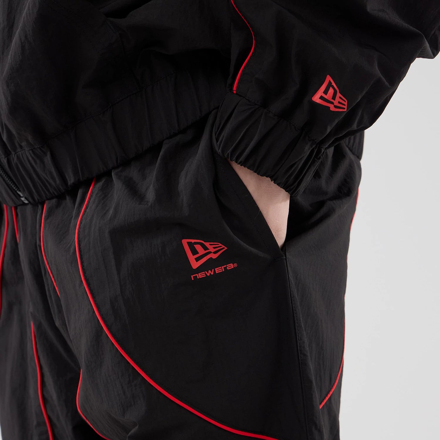 The model is wearing these Red Bull Racing Piping Track Pants in black. 6