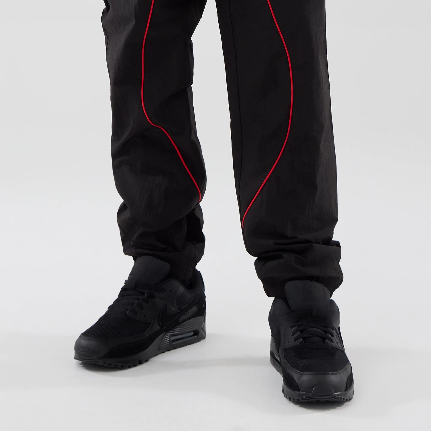 The model is wearing these Red Bull Racing Piping Track Pants in black. 7