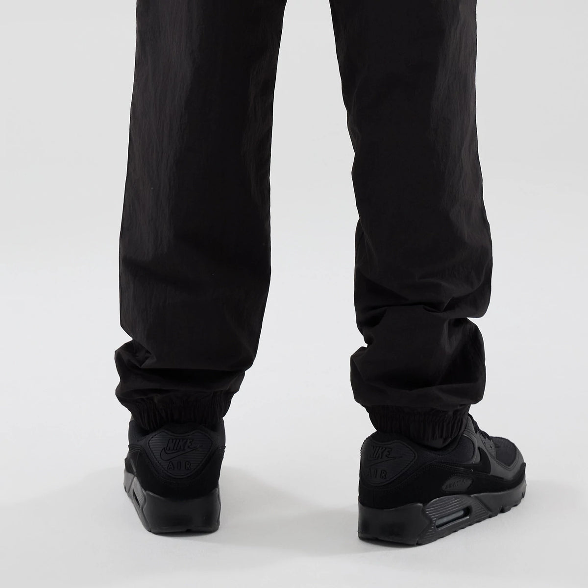 The model is wearing these Red Bull Racing Piping Track Pants in black. 3