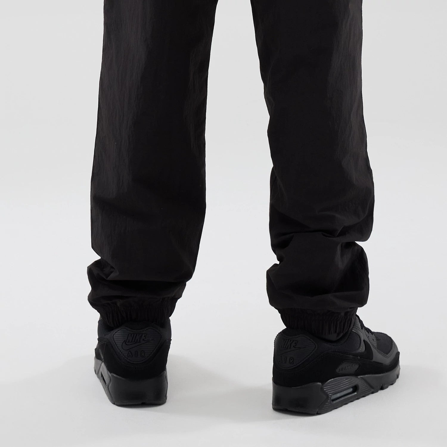 The model is wearing these Red Bull Racing Piping Track Pants in black. 3