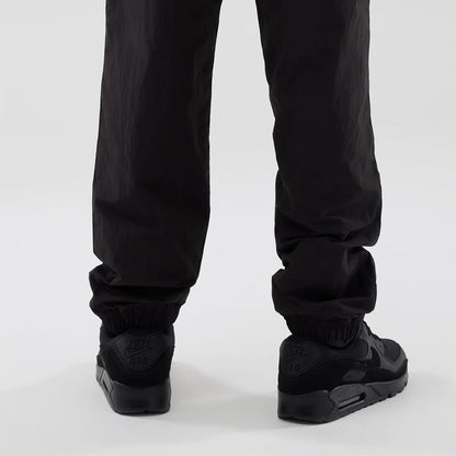 The model is wearing these Red Bull Racing Piping Track Pants in black. 3