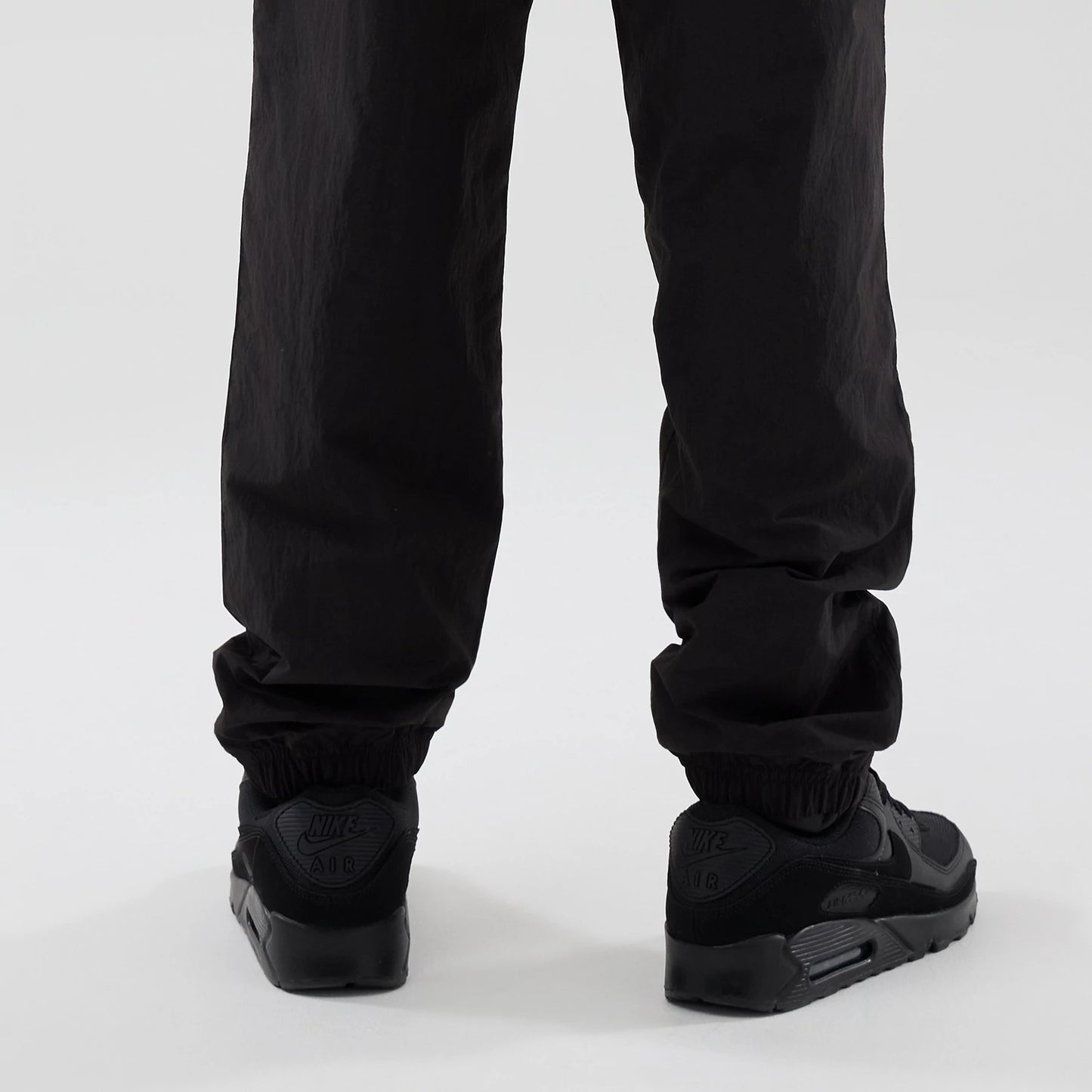 The model is wearing these Red Bull Racing Piping Track Pants in black. 3