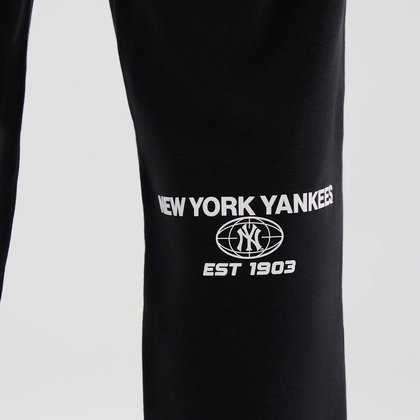 The model is wearing these MLB Logo Graphic New York Yankees Straight Leg Joggers in black. 6