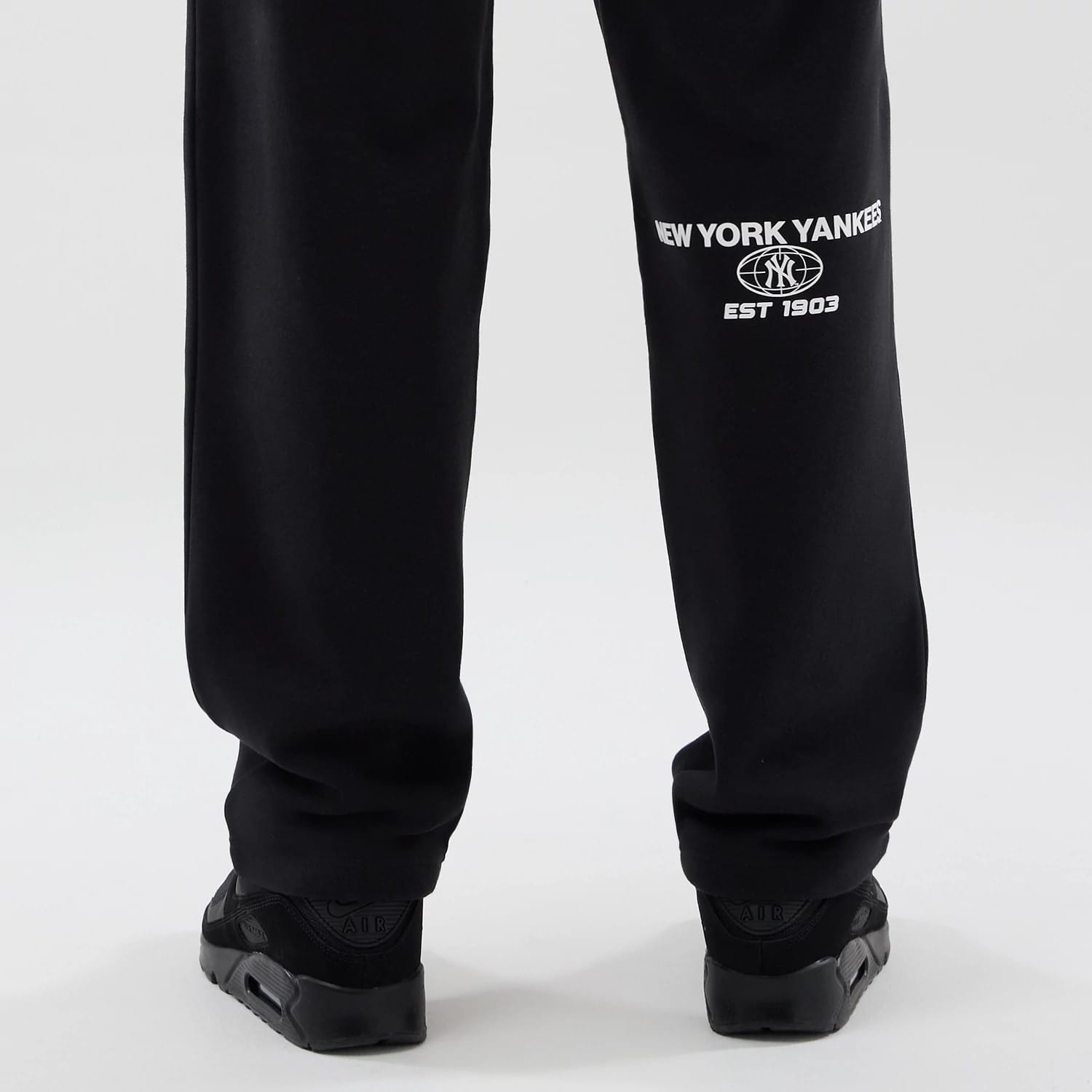 The model is wearing these MLB Logo Graphic New York Yankees Straight Leg Joggers in black. 7