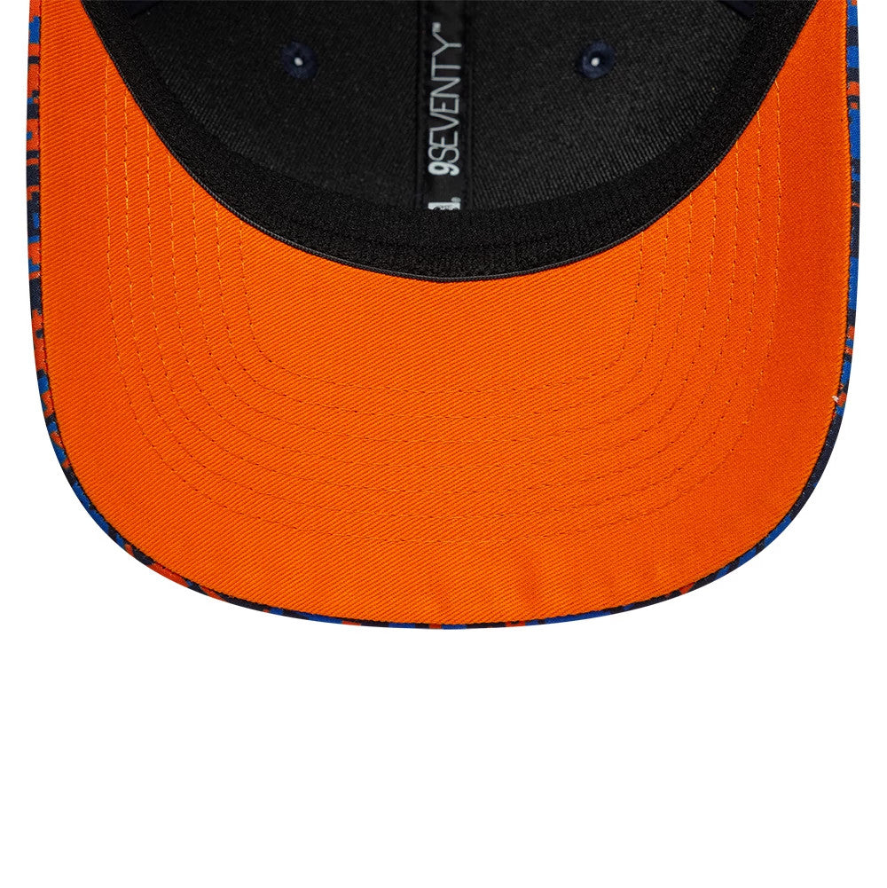 Red Bull Racing Digi Camo Dark Blue New Era 9SEVENTY Stretch Snap Adjustable Cap, inside view showing a bright orange undervisor, black sweatband, and branded taping with the 9SEVENTY label running along the centre.