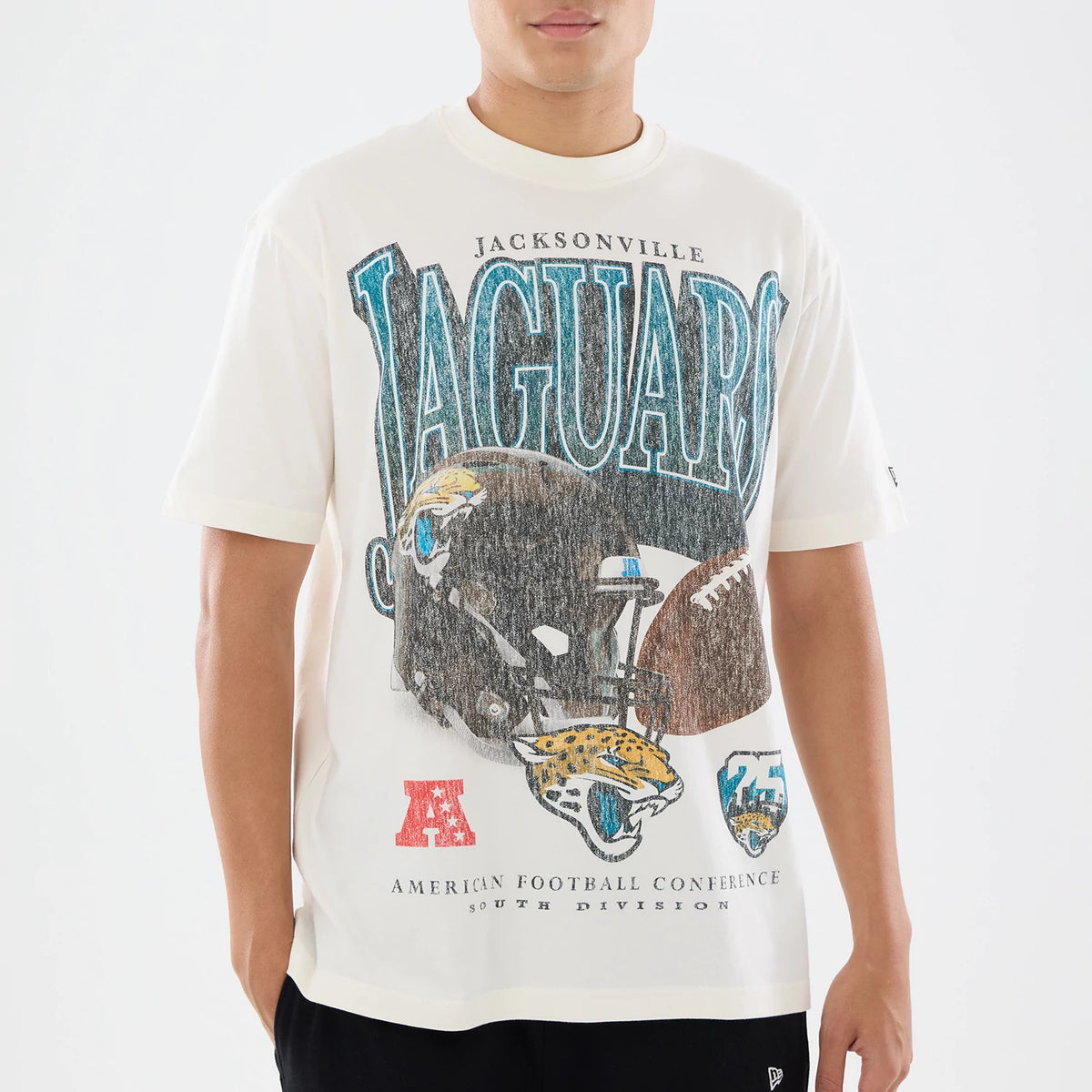 New Era Jacksonville Jaguars NFL Sport Classic Cream T-Shirt, front view on a model featuring large JAGUARS lettering across the chest, a graphic of a football helmet and jaguar head below, and an embroidered New Era logo on the left sleeve.