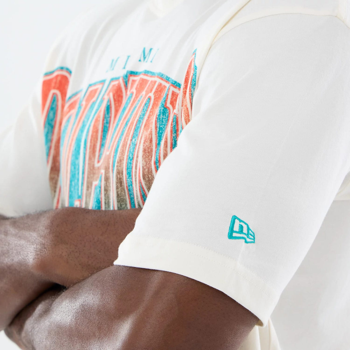 The model is wearing this NFL Sport Classic Miami Dolphins T-Shirt in cream. 5