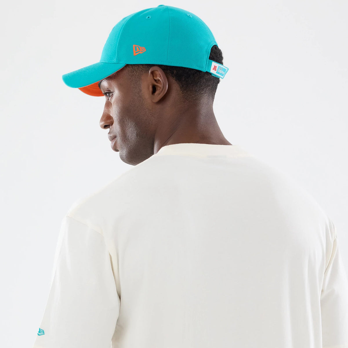 The model is wearing this NFL Sport Classic Miami Dolphins T-Shirt in cream. 7