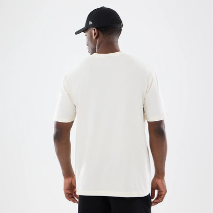 New Era Vancouver Grizzlies NBA Sport Classic Cream T-Shirt, back view on a model styled with a black New Era cap, showcasing the plain cream fabric of the T-shirt with short sleeves and a simple round neckline.