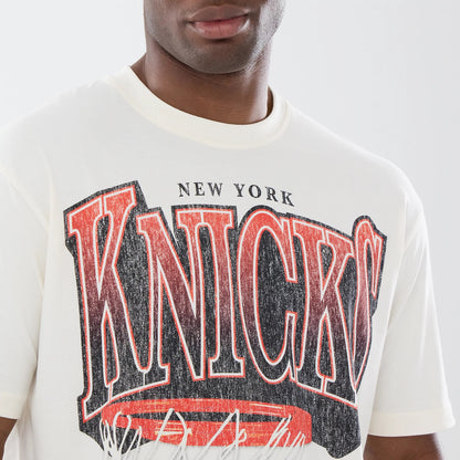 The model is wearing this NBA Sport Classic New York Knicks T-Shirt in cream. 5