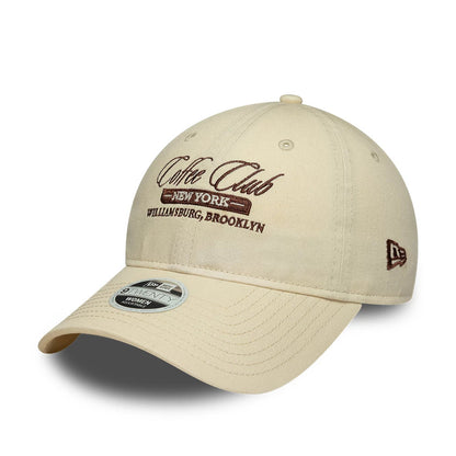 Pictured is this Womens New Era Café Slogan 9TWENTY cap in cream. 1